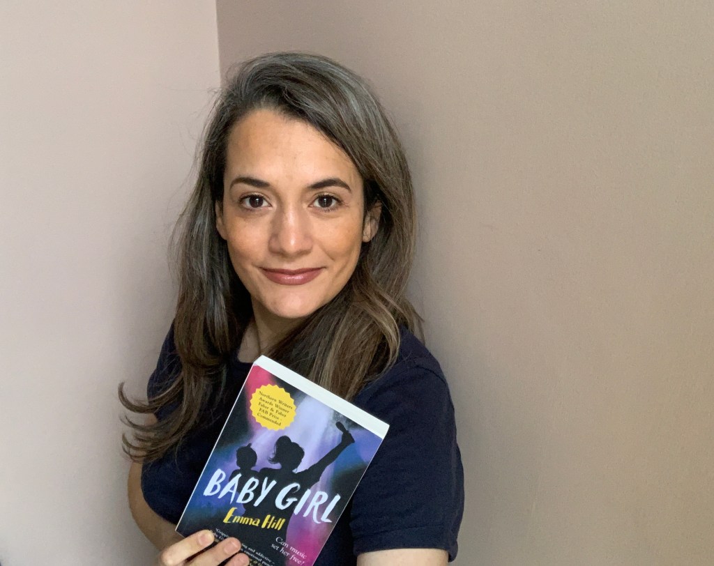 Emma Hill with a copy of her book, Baby Girl